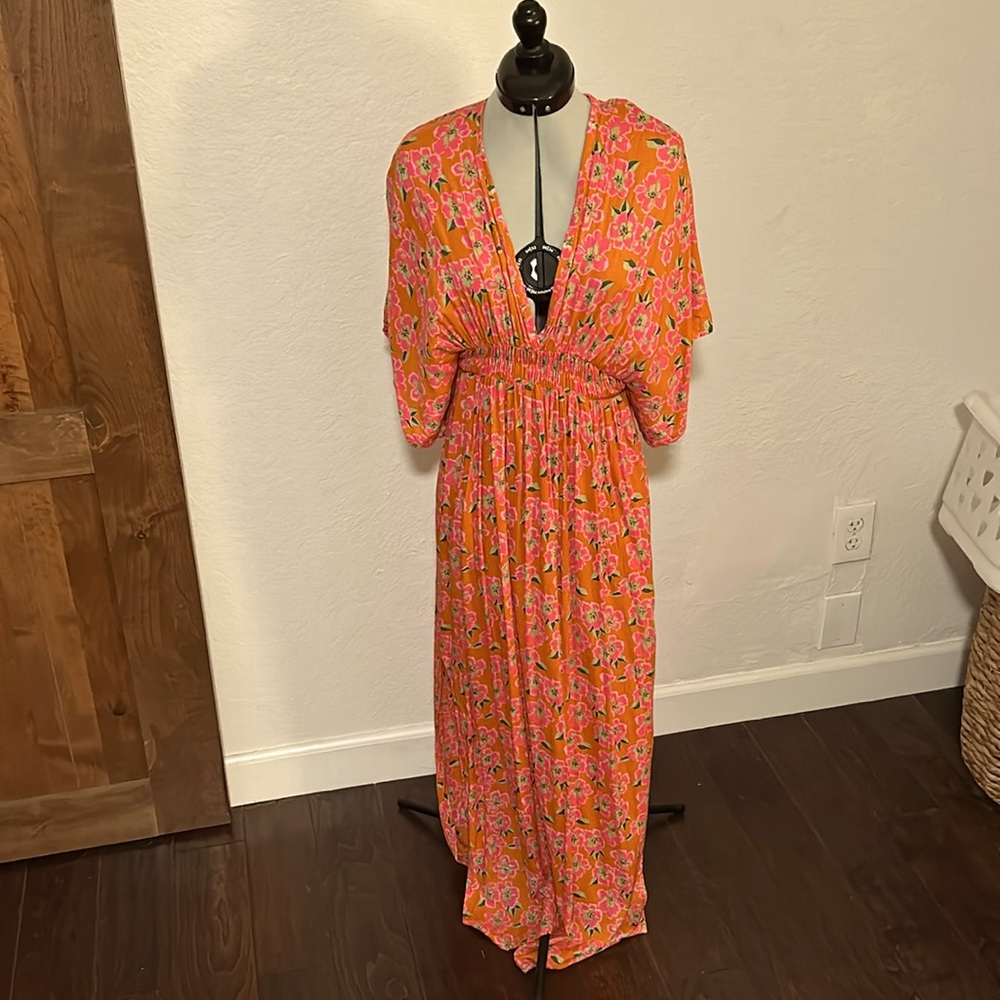 Orange and pink floral maxi dress. Open back, low cut front. Elasticized waist.